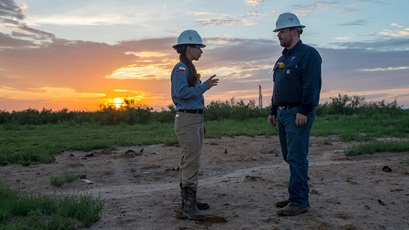 Two workers talking at the X16 oil rig drill site. Site is in the Permian Basin located in West Texas and Southeast New Mexico.