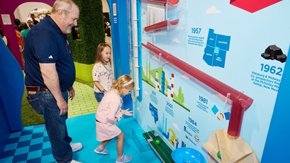 Donald Bush watches as young visitors to the 2025 New Mexico State Fair interact with attractions at the Chevron STEM Zone.