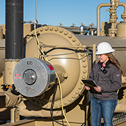 A worker inspecting tankless facility equipment